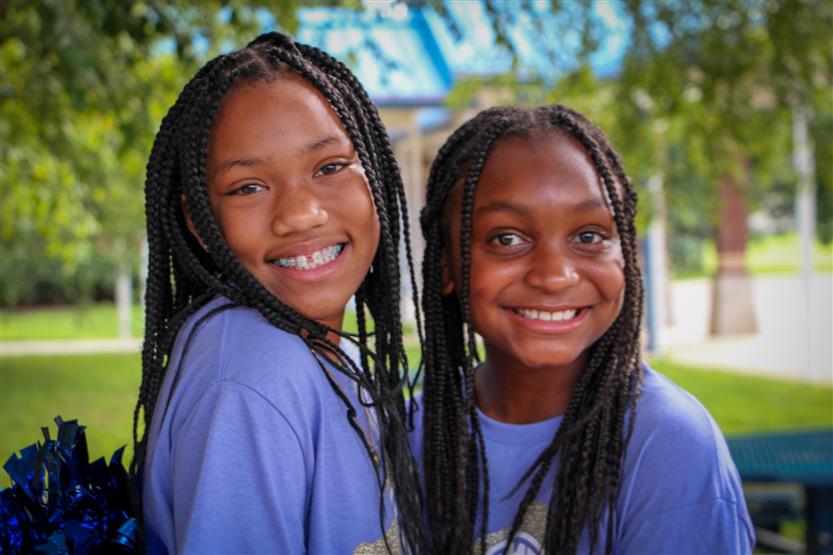 Two girls smile